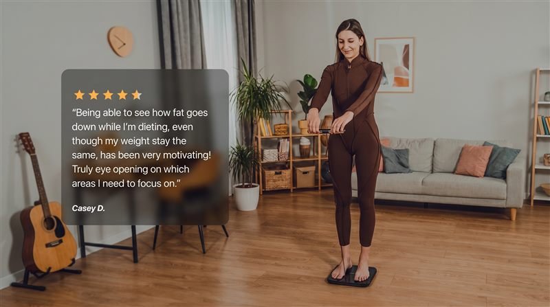 Customer using the Hume Body Pod at home, with a five-star review about tracking body fat changes